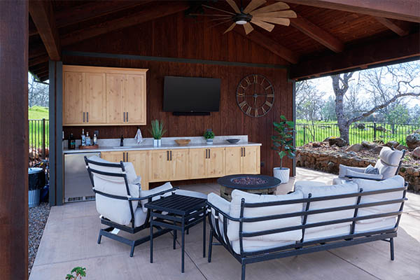 outdoor kitchen area with firepit in the middle