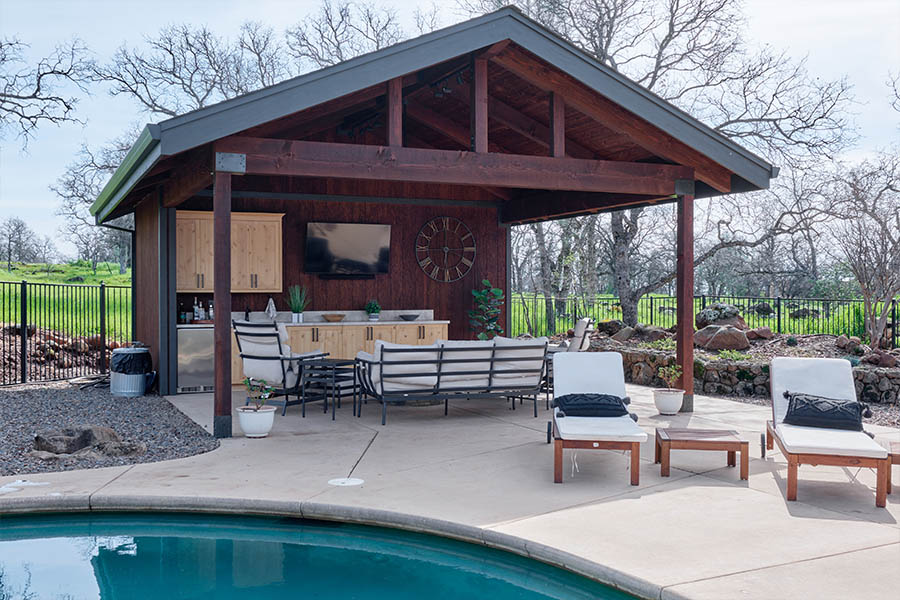 outdoor kitchen area near a pool