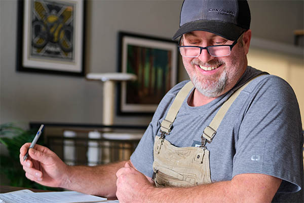 Justin Cantalupo works on a blueprint of a kitchen remodel