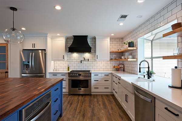 white kitchen with white tile backsplash and wooden shelves